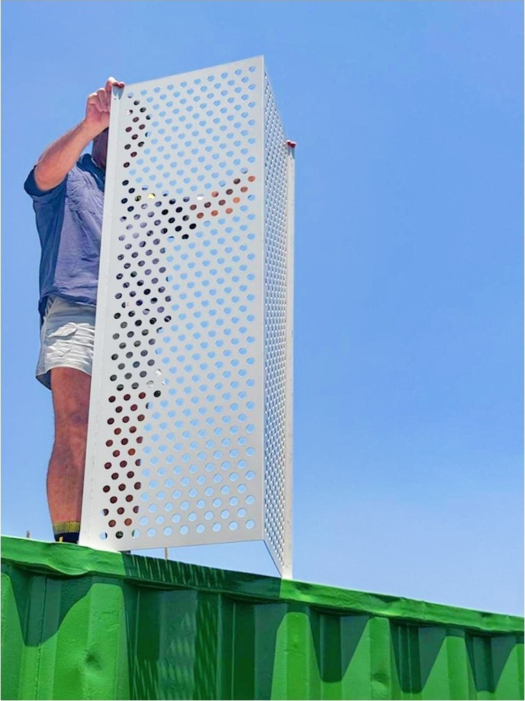 Perforated panel detail against a blue sky